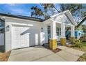 House exterior with a white garage door and yellow brick accents at 3206 E 38Th Ave, Tampa, FL 33610