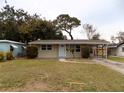 Tan single story home with carport and small yard at 435 92Nd N Ave, St Petersburg, FL 33702