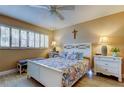 Bedroom with white bed frame, two nightstands, and ceiling fan at 4780 Cove Cir # 209, St Petersburg, FL 33708