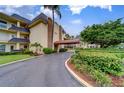 Building entrance with covered walkway and landscaping at 4780 Cove Cir # 209, St Petersburg, FL 33708