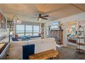 Bright living room with comfy sectional sofa and brick fireplace at 5220 Brittany S Dr # 201, St Petersburg, FL 33715