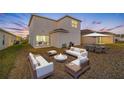 Spacious backyard with patio furniture and fire pit at 5913 Laurelcrest Gln, Palmetto, FL 34221