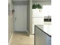 Clean entryway with tiled floor and a view into the kitchen at 6033 34Th W St # 45, Bradenton, FL 34210