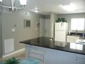 Open concept kitchen with breakfast bar, looking into the living room at 6033 34Th W St # 45, Bradenton, FL 34210