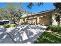 Two-story house with a two-car garage and mature landscaping at 10734 Moss Island Dr, Riverview, FL 33569