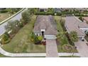 House with tile roof, driveway, and well-maintained lawn at 11465 Bitola Dr, Odessa, FL 33556