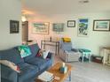 Bright and airy living room with comfortable seating and large windows at 1279 Dinnerbell E Ln, Dunedin, FL 34698