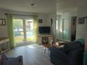 Spacious living room featuring light wood floors and plenty of natural light at 1279 Dinnerbell E Ln, Dunedin, FL 34698