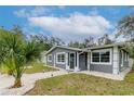 Refreshed gray house exterior, walkway, and lush landscaping at 1341 Springdale St, Clearwater, FL 33755
