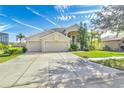 Two-story house with a three-car garage and spacious driveway at 18119 Diamond Cove Ct, Tampa, FL 33647
