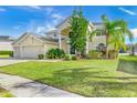 Two-story house with a three-car garage and manicured lawn at 18119 Diamond Cove Ct, Tampa, FL 33647