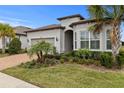 One-story house with gray siding, brown roof, and a brick paver driveway at 19771 Ship Wheel Way, Land O Lakes, FL 34638