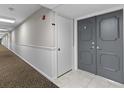 Condo hallway with carpet and neutral walls at 220 Belleview Blvd # 607, Belleair, FL 33756