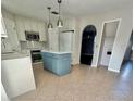 Spacious kitchen with an island, stainless steel appliances, and white cabinets at 24932 Ravello St, Land O Lakes, FL 34639