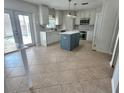 Modern kitchen featuring an island, stainless steel appliances, and white cabinets at 24932 Ravello St, Land O Lakes, FL 34639