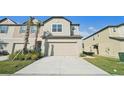 Two-story townhome with attached garage and well-manicured lawn at 32109 Pond Apple Bnd, San Antonio, FL 33576