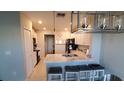 Modern kitchen with white cabinets, granite countertops, and stainless steel appliances at 4410 Summer Savory St, Tampa, FL 33619