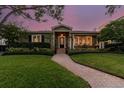 House exterior at dusk showcasing landscaping and brick pathway at 526 19Th Ne Ave, St Petersburg, FL 33704