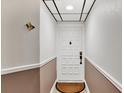 Simple condo entryway with a white door and neutral-colored walls at 6365 Bahia Del Mar Blvd # 604, St Petersburg, FL 33715