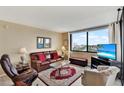 Living room with leather furniture and a large window with city view at 6365 Bahia Del Mar Blvd # 604, St Petersburg, FL 33715