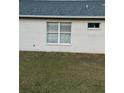 Rear view of house showcasing simple exterior at 6905 Sotra St, Wesley Chapel, FL 33545
