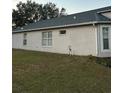 Side view of house showing windows and yard at 6905 Sotra St, Wesley Chapel, FL 33545