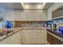 Bright kitchen with granite countertops and stainless steel appliances at 905 Hidden Harbour Dr, Indian Rocks Beach, FL 33785
