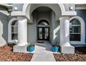 Elegant entryway with arched columns and double doors at 9413 Swift Creek Cir, Dover, FL 33527