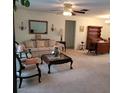 Living room with sofa, coffee table, and views to dining area at 9608 41St N St # 2, Pinellas Park, FL 33782