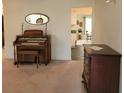 Living room with an organ, chest of drawers, and view into the kitchen at 9608 41St N St # 2, Pinellas Park, FL 33782