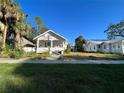 White bungalow home with a front yard at 1105 W De Leon St, Tampa, FL 33606