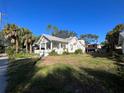 White bungalow home with a side yard at 1105 W De Leon St, Tampa, FL 33606