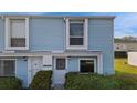 Light blue two-story home with green landscaping at 11813 Cypress Hill Cir # 11813, Tampa, FL 33626
