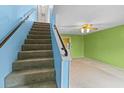 Staircase leading to upper level with light blue walls at 11813 Cypress Hill Cir # 11813, Tampa, FL 33626