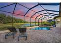 Enclosed pool and spa with a stunning sunset view at 13819 Swiftwater Way, Bradenton, FL 34211