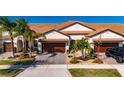 Two-story house with a brick driveway and palm trees at 16909 April Plush Dr, Wimauma, FL 33598