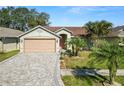 House exterior featuring a paved driveway and palm trees at 2115 Cattleman Dr, Brandon, FL 33511