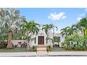 White stucco home with lush landscaping and a walkway at 220 14Th N Ave, St Petersburg, FL 33701