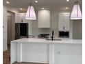 Modern kitchen with white cabinets and large island at 225 Tournament Rd, Rotonda West, FL 33947