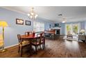 Elegant dining area with hardwood floors and a piano at 274 Madeira Cir, St Petersburg, FL 33715