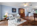 Living room with hardwood floors, sofa, and wooden cabinet at 274 Madeira Cir, St Petersburg, FL 33715