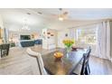 Bright dining room with a large wooden table and hardwood floors at 3113 Chamblee Ln, Clearwater, FL 33759