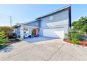 Gray and white house with a red door and landscaping at 3113 Chamblee Ln, Clearwater, FL 33759