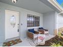 Inviting front porch with two chairs and welcome decor at 4084 Lake Blvd, Clearwater, FL 33762