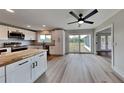 Modern kitchen with white cabinets, stainless steel appliances, and a butcher block island at 4411 Mongite Rd, North Port, FL 34287