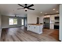 Open concept kitchen with white cabinets and stainless steel appliances at 4411 Mongite Rd, North Port, FL 34287