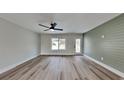 Living room with light walls, wood-look floors, and a ceiling fan at 4411 Mongite Rd, North Port, FL 34287