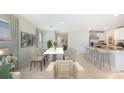 Open dining area with view into kitchen and living room at 5018 Rocky Coast Pl, Palmetto, FL 34221