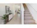 Bright entryway with tile flooring, staircase, and view to dining area at 5018 Rocky Coast Pl, Palmetto, FL 34221