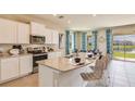 Spacious kitchen featuring granite countertops and stainless steel appliances at 5640 Silver Moonlight Dr, Palmetto, FL 34221